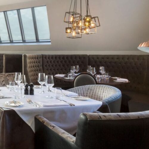 Indigo Restaurant Banquette table, chairs and lighting for hotel dining