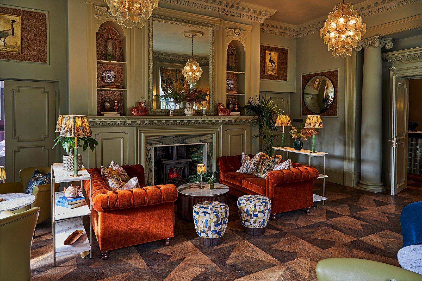 Burnham Beeches Hotel Lounge featuring Winchester Sofas in red velvet and Imani stool with neoclassical influences.