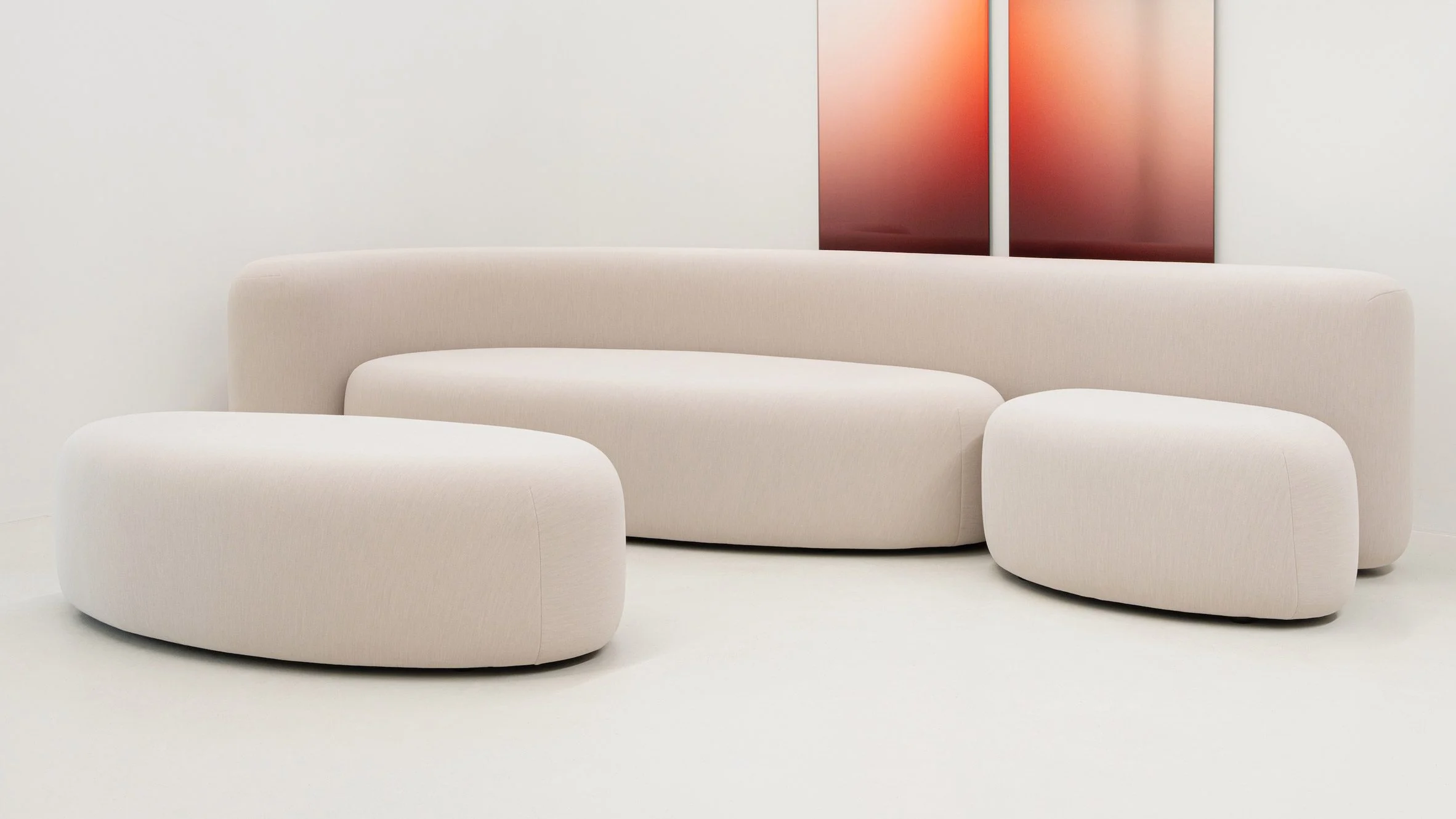 Upholstered in recycled polyester with no visible seams, Lisse modular sofa with poufs features oversized oval shapes and a striking monolithic silhouette.