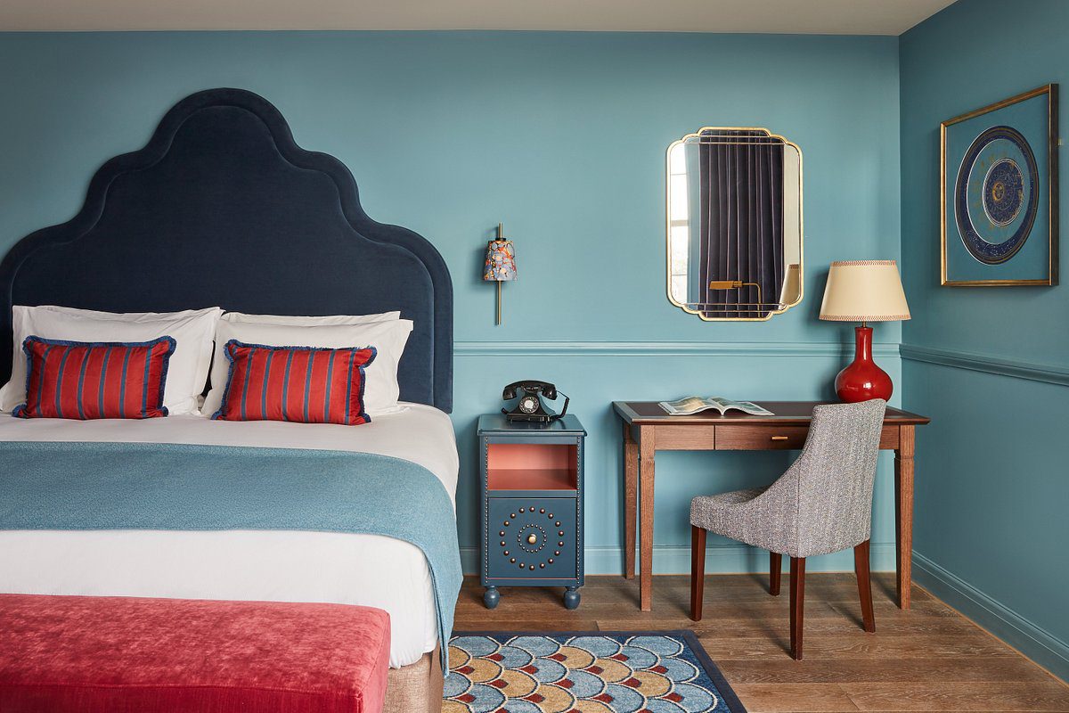 Indigo Exeter Hotel bedroom featuring bespoke Bourne Furniture, including headboard, tables, and seating.