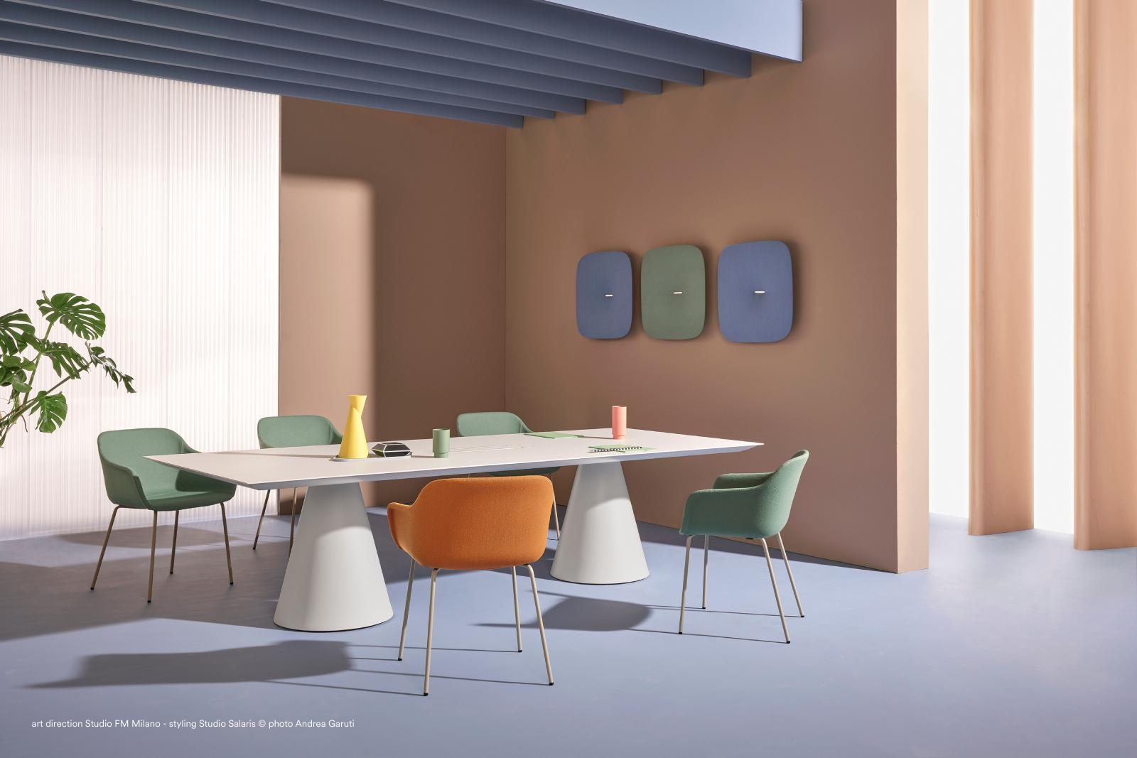 Office space featuring high-backed sofas and mobile partitions to reduce noise and support a calm work environment